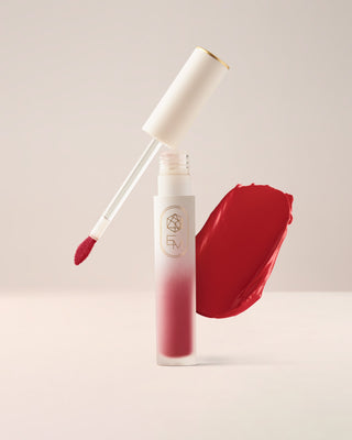 EM Cosmetics Soft Spoken Velvet Lip Creme in Flirt, a playful coral pink lipstick with a modern velvet finish.