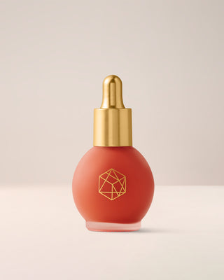 EM Cosmetics Color Drops Serum Blush in Sunset Sky, a warm amber liquid blush for a sun-kissed, radiant, dewy glow.