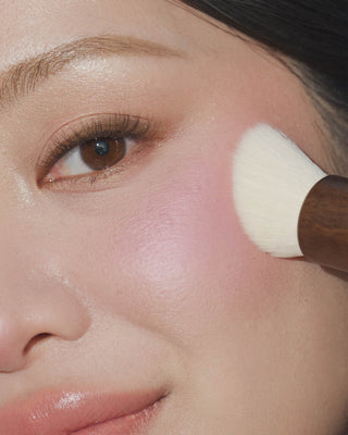 EM Cosmetics Komorebi Brush shown with Heaven's Glow Blush, perfect for applying powder formulas seamlessly.