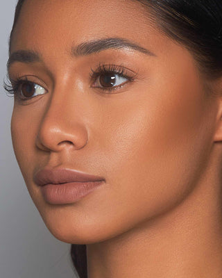 Before-and-after of model using EM Cosmetics Corselette Bronzer in Sensual to sculpt and define the face.