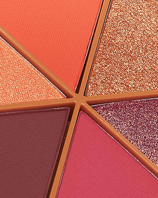 Arm swatches of EM Cosmetics Divine Skies in Faded Clementine, showing matte and shimmer orange tones.