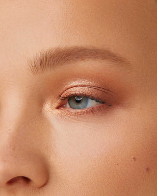 Model with light skin wearing EM Cosmetics Divine Skies Eyeshadow in Magic Hour.