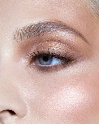 Model with light skin wearing EM Cosmetics Divine Skies Palette in Rodin for a natural, cool rose eye look.