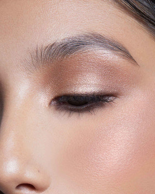 Model with medium skin wearing EM Cosmetics Divine Skies Palette in Rodin for a defined, rosy brown eye look.
