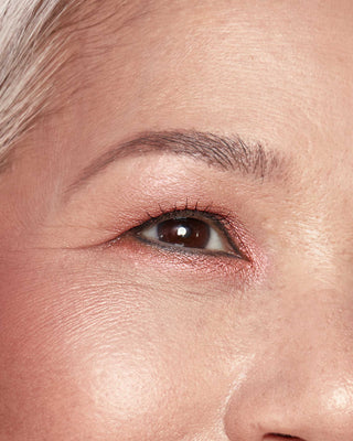 Model with medium skin wearing EM Cosmetics Divine Skies in Venetian Rose for a warm, vintage rose eye look.