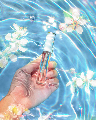Creative beauty shot of a model's lips with a high-shine, glossy finish from EM Cosmetics Morning Dew Lip Gloss.