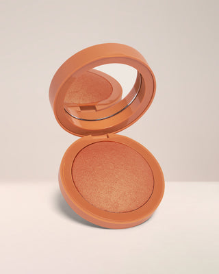 Open compact of EM Cosmetics Heaven's Glow Radiant Veil Blush in Faded Clementine, showing the marbled, baked texture.