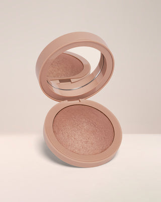 Open compact of EM Cosmetics Heaven's Glow Radiant Veil Blush in Rococo, showing the marbled, satin powder texture.