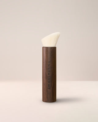 The EM Cosmetics Komorebi Face and Cheek Brush, featuring soft, angled bristles for effortless blush and bronzer blending.