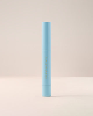 Closed tube of EM Cosmetics Lip Cushion Luminizer in Clear Quartz, shown in its sleek, translucent packaging.