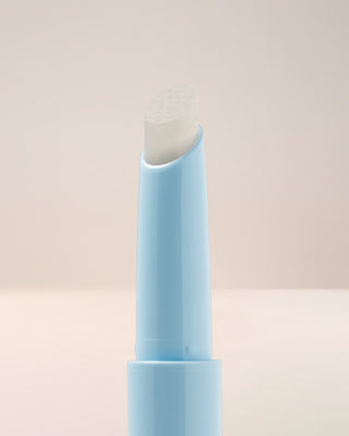 Macro texture shot of EM Cosmetics Lip Cushion in Clear Quartz, highlighting the glossy, nourishing formula.