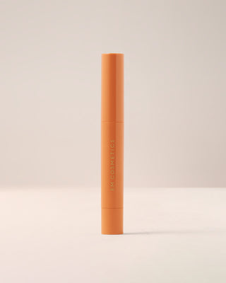 EM Cosmetics Lip Cushion Tinted Lip Luminizer in Faded Clementine in its closed packaging.