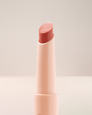 Close-up texture shot of EM Cosmetics Lip Cushion in Magic Hour showing the glossy finish.