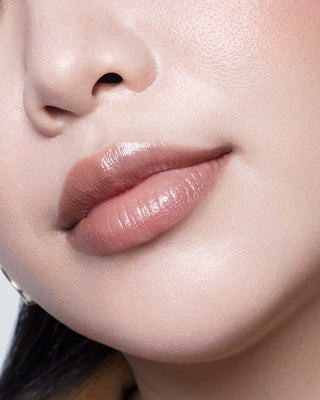 Michelle Phan wearing EM Cosmetics Lip Cushion in Mona Lisa for a sheer, nourishing wash of nude brown color.