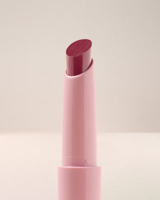 Close-up texture shot of EM Cosmetics Lip Cushion in Mystic showing the glossy berry finish.