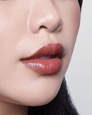 Michelle Phan wearing EM Cosmetics Lip Cushion in Van Gogh for a sheer, nourishing wash of deep rose color.