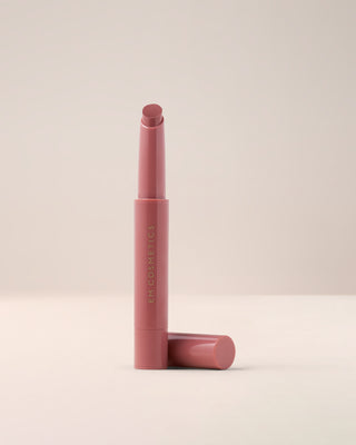 EM Cosmetics Lip Cushion Tinted Lip Luminizer in Venetian Rose uncapped to show the vintage rose shade.
