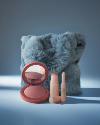 Editorial still life featuring EM Cosmetics blush and lip products in cool pink winter tones.