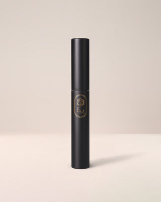 The sleek, minimalist white tube of EM Cosmetics Shapeshift Tubing Mascara, a lengthening and volumizing formula.