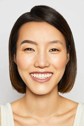 Model Mikaela wearing EM Cosmetics Micro Fluff Brow Cream in Universal Taupe for defined brows.