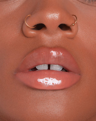 EM Cosmetics Everglass Lip Dew in Dream, a clear shimmer shade, shown in its sleek, minimalist packaging.