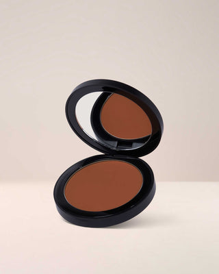 EM Cosmetics Corselette Sculpting Bronzer in Sultry, a warm medium bronzer, shown in its open compact.