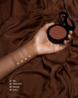 Arm swatches of EM Cosmetics Corselette Sculpting Bronzer in Sultry, showing the soft, matte powder texture.