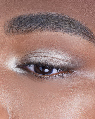 Male model wearing EM Cosmetics Cosmic Pearl Eyeshadow in Luna, enhancing the eyes with a golden glow.