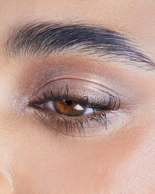 Model wearing EM Cosmetics Cosmic Pearl Eyeshadow in Moonrise for a soft, shimmering champagne eye look.