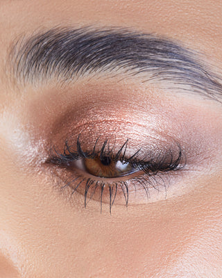 Model wearing EM Cosmetics Cosmic Pearl Eyeshadow in Wish for a soft, shimmering beige eye look.