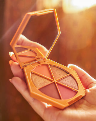 EM Cosmetics Divine Skies Palette in Faded Clementine, shown with its warm orange packaging.
