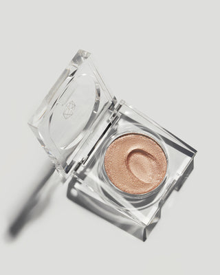 Closed compact of EM Cosmetics Cosmic Pearl Eyeshadow in Wish, shown in its sleek nude packaging.