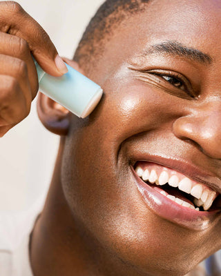 Close-up on a model's glowing skin, enhanced by the hydrating, non-sticky EM Cosmetics Face Cuddle Moisture Balm.