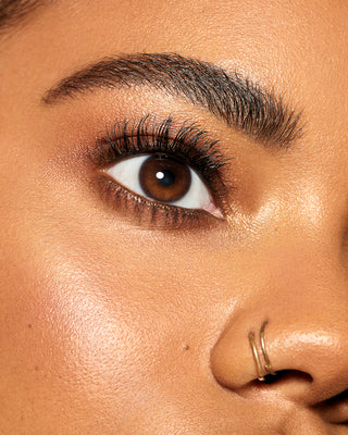 Model wearing EM Cosmetics Fine Liner Brow Pencil in Ebony for bold defined brows.