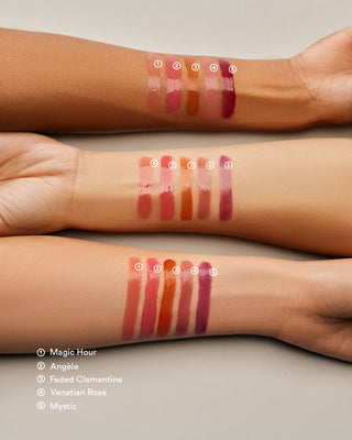 Arm swatch of EM Cosmetics Lip Cushion in Faded Clementine showing the sheer glossy texture.
