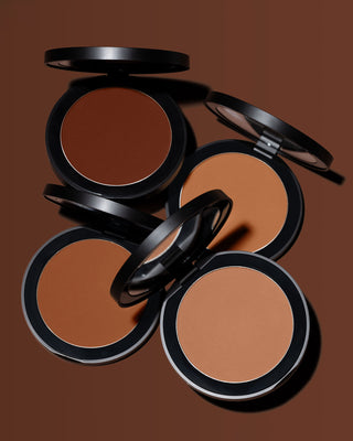 Stylized shot of EM Cosmetics Corselette Sculpting Bronzer in Silhouette, highlighting the fine powder texture.