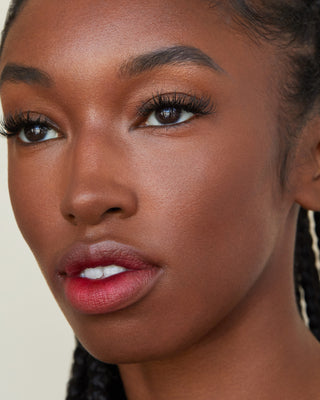 Model with medium skin wearing EM Cosmetics So Soft Multi-Faceplay in Pangea for a deep, bronze contour.