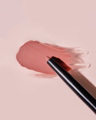 Arm swatch of EM Cosmetics Soft Blur Velvet Lip Liner in Bunny showing the matte pink shade.