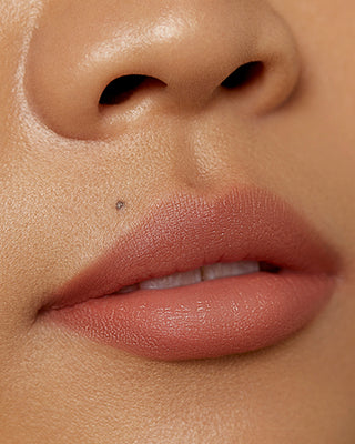 Model Valerie wearing EM Cosmetics Soft Blur Velvet Lip Liner in Bunny for a matte finish.