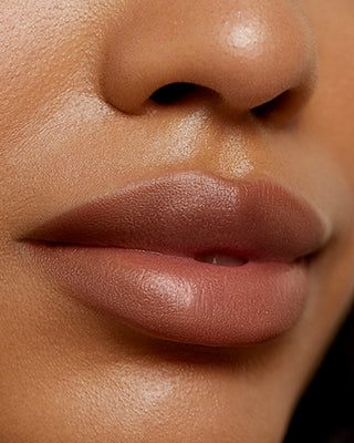 Model Khali wearing EM Cosmetics Soft Blur Velvet Lip Liner in Teddy for a warm matte look.