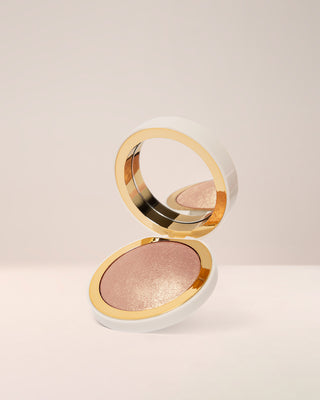 EM Cosmetics Sunscape Highlighter in Clarity, a cool champagne shade, shown in its open compact.