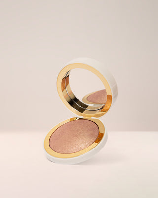 EM Cosmetics Sunscape Highlighter in Majesty, a warm bronze gold shade, shown in its open compact.