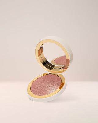EM Cosmetics Sunscape Highlighter in Serenity, a soft rose gold shade, shown in its open compact.